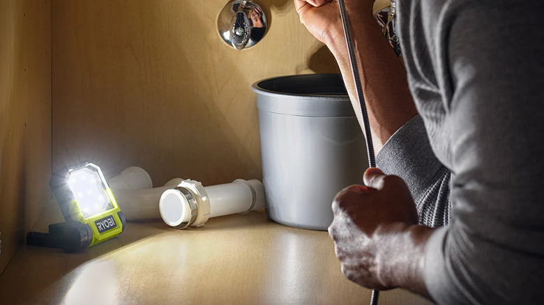 Ryobi USB Lithium flip light illuminating a workspace