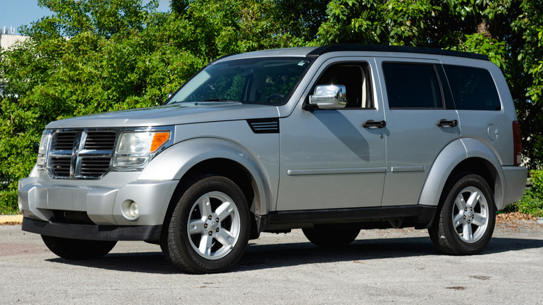A silver 2009 Dodge Nitro SUV parked outside.