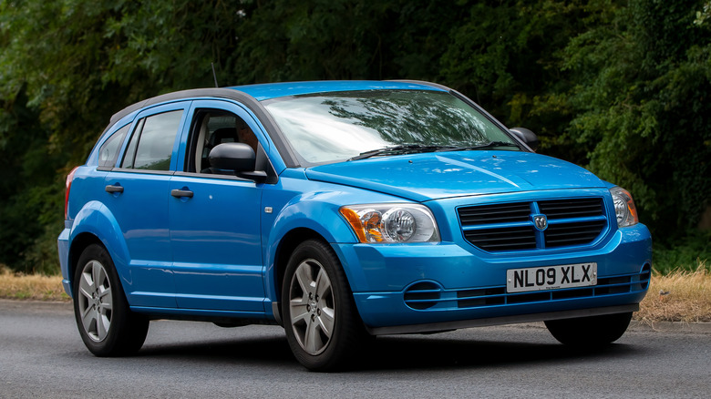 A 2009 blue Dodge Caliber being driven down a road.