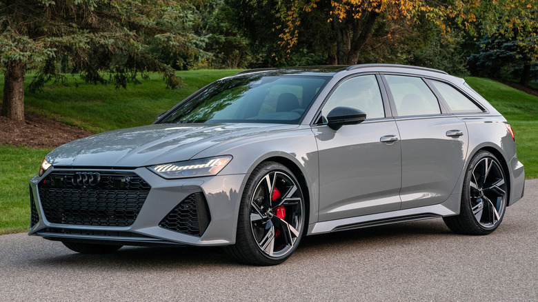 Front 3/4 view of gray Audi RS6 Avant parked in front of trees.