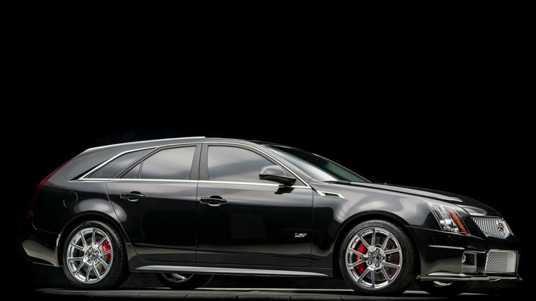 Side view of black Cadillac CTS-V wagon parked in black studio.