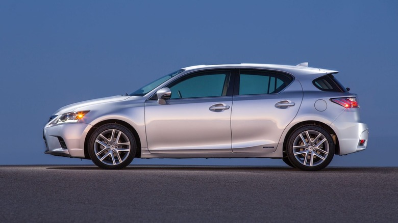 Silver Lexus CT 200h parked against blue backdrop