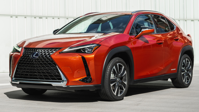 Orange Lexus UX 250h parked in front of a white building