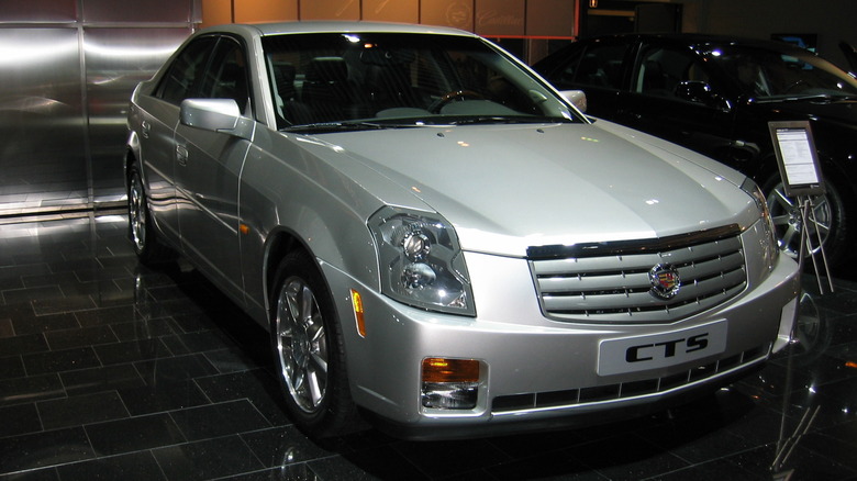 Front 3/4 view of a silver first generation Cadillac CTS at an auto show