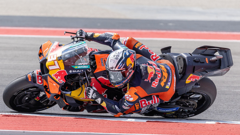 Man taking a steep angle on turn in motorcycle race