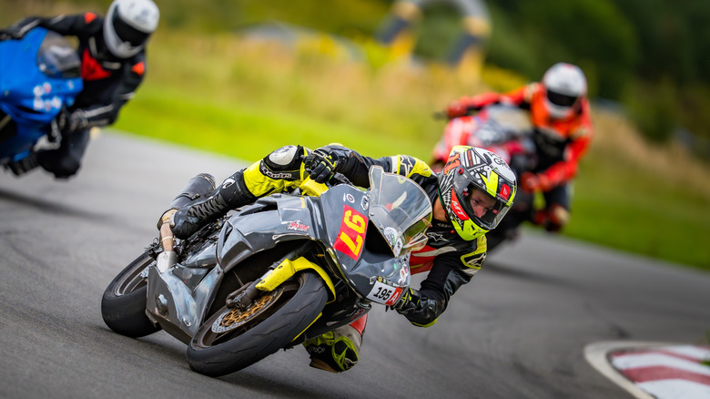 Three motorcycles taking a turn in a race