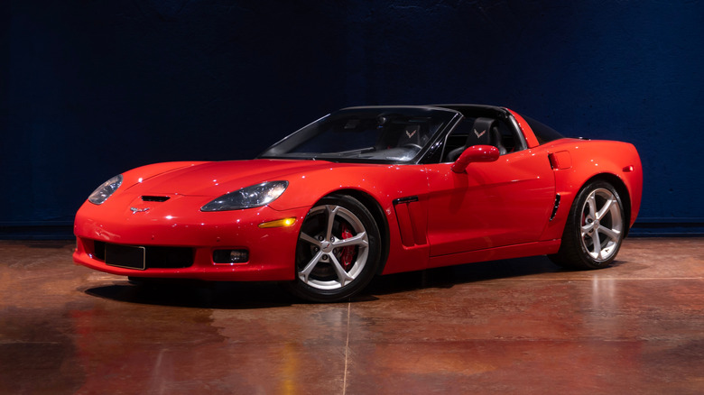 A C6 Chevrolet Corvette in red, front 3/4 view, targa roof removed