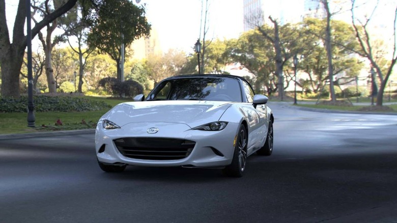Mazda MX-5 Miata in suburb, front 3/4 view, white exterior