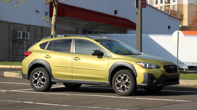 Yellow Subaru Crosstrek parked in an empty parking lot