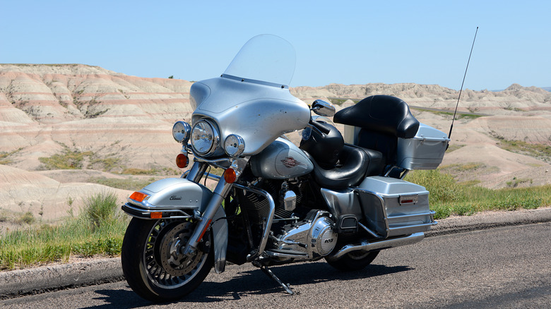 A Silver Harley-Davidson Electra Glide motorcycle parked on a road.