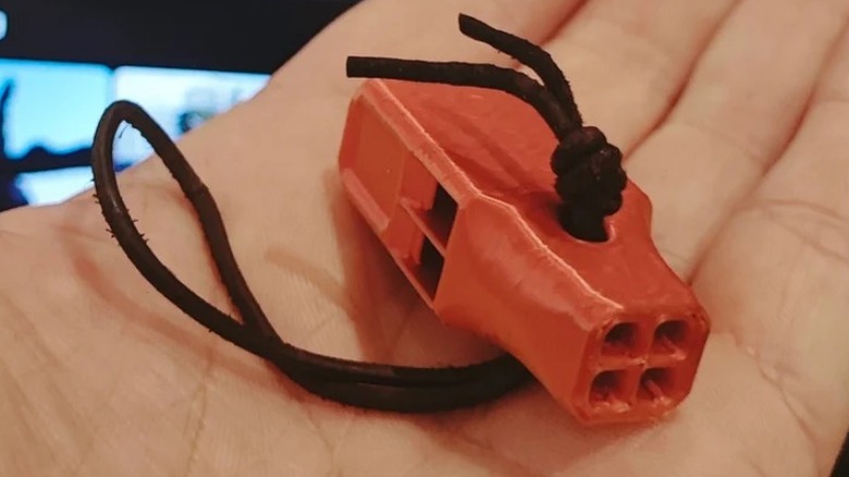 Backpacking Whistle in person's hand