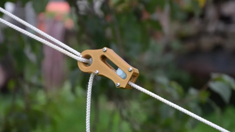 Automatic Paracord Rope Tensioner holding white paracord