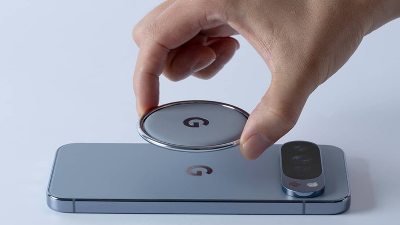 A hand attaching the pixelsnap ring stand to the back of a pixel phone