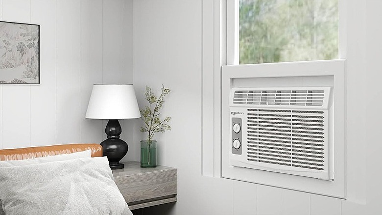 White air conditioner installed in a bedroom.