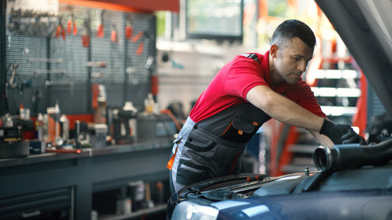 A mechanic working on a car