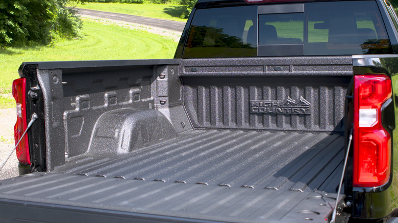 Outside view of factory bed liner in black 2019 Chevy Silverado High Country pickup truck.