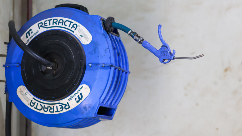 A wall-mounted, retractable air hose reel