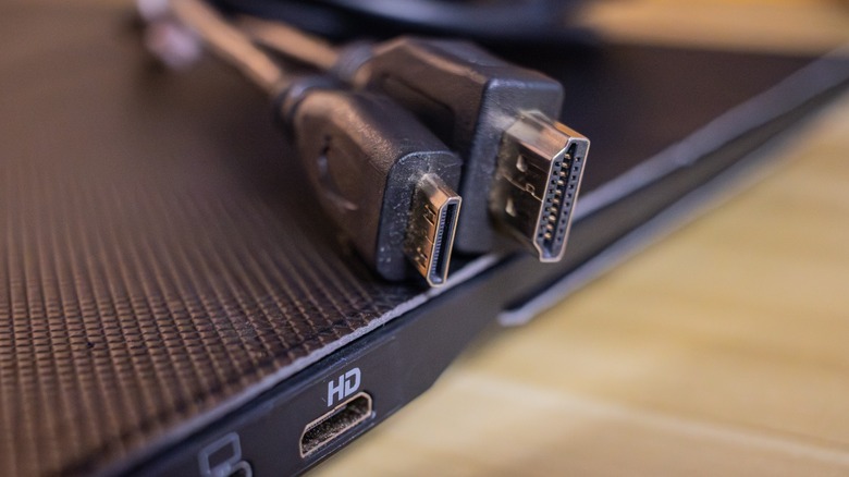 A mini-HDMI to HDMI adapter cable on a laptop.