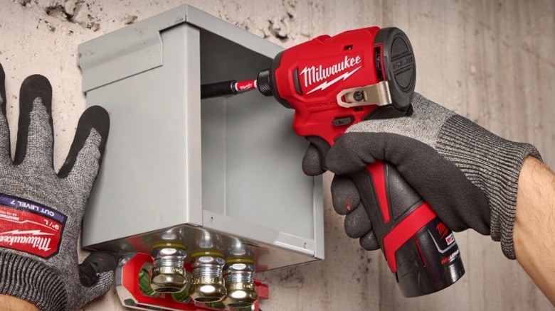 Person using Milwaukee M12 Subcompact Drill in power box
