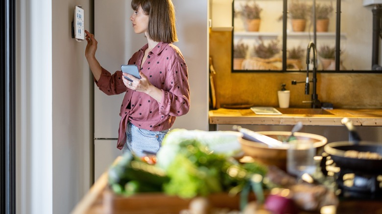 woman using display in kitchen