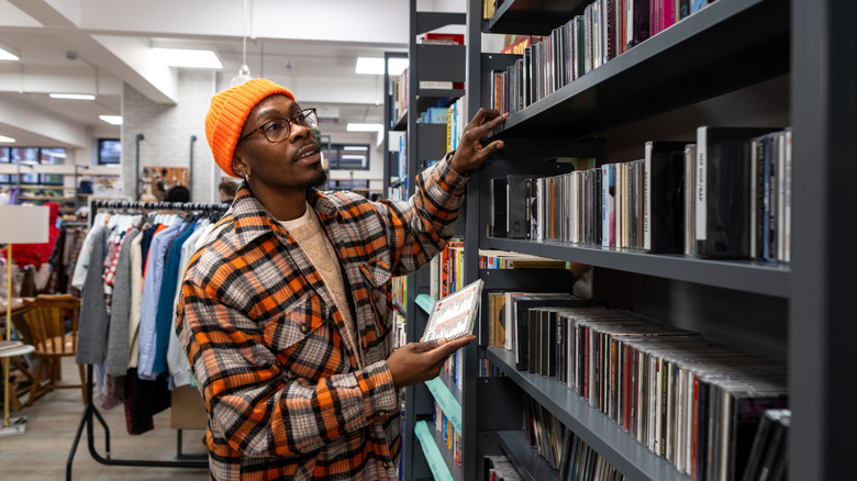 Man browsing CD shelf in a thrift store