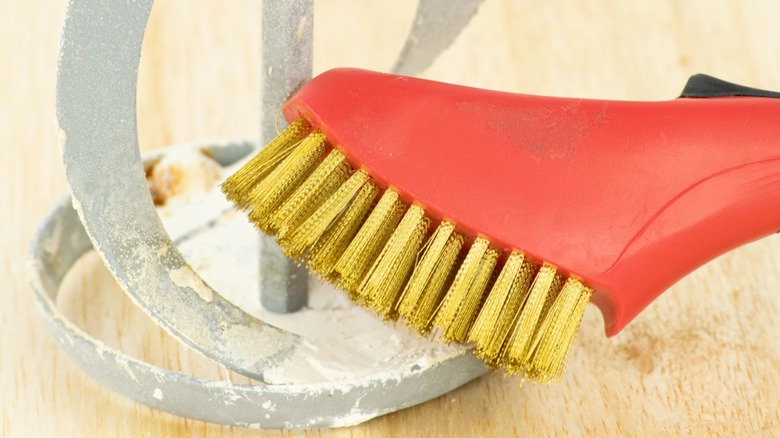 A wire brush scrubbing metal decor.