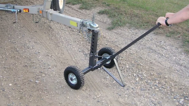Person using a trailer dolly to move a trailer