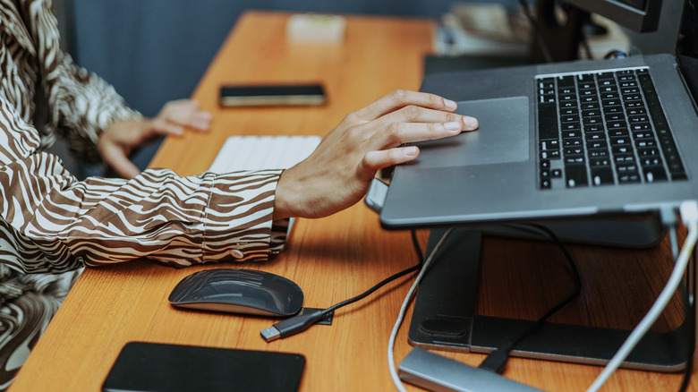 Person working with a laptop in docked orientation