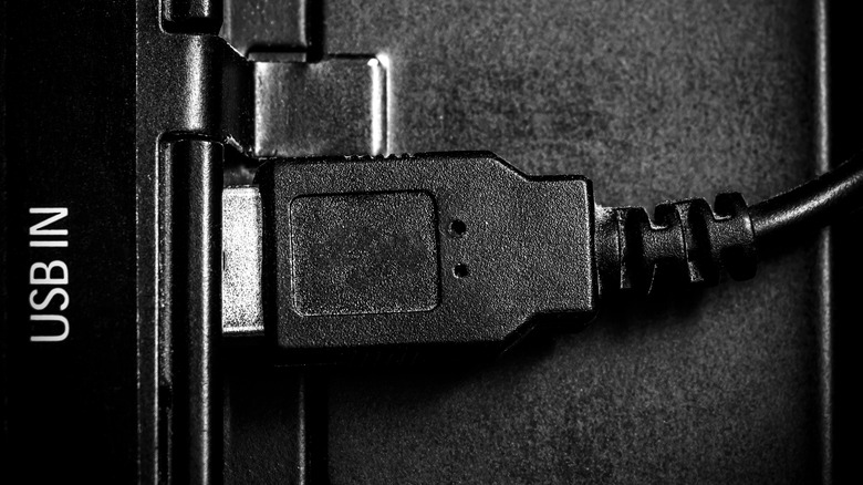 Black USB cable plugged into TV port