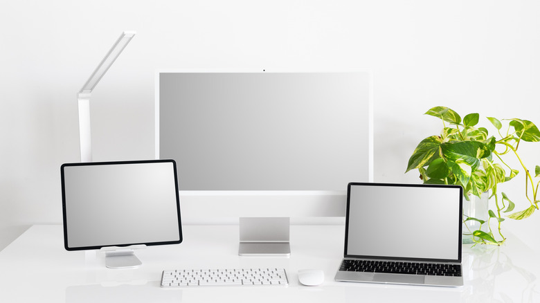 iPad on desktop with computer and peripherals