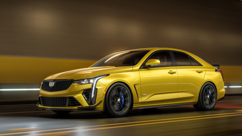 Front 3/4 view of gold Cadillac CT-4 Blackwing driving in tunnel.
