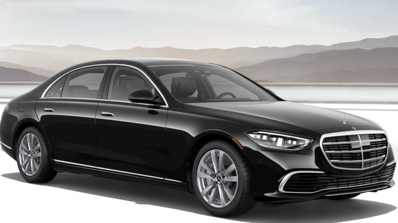 A black Mercedes-Benz S580 against a landscape background