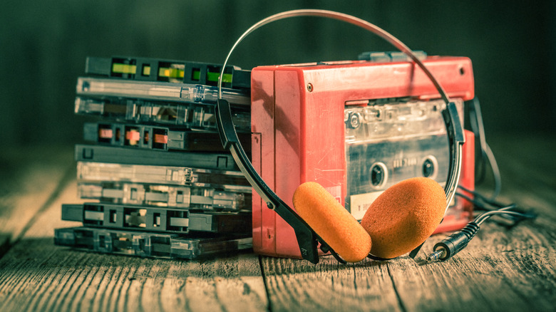 Cassette tapes next to red walkman