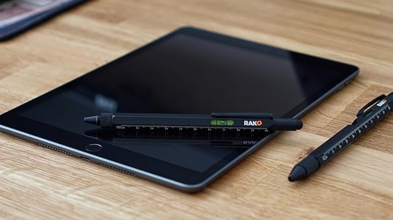 RAK Multi-tool Pen resting on a tablet and another beside it