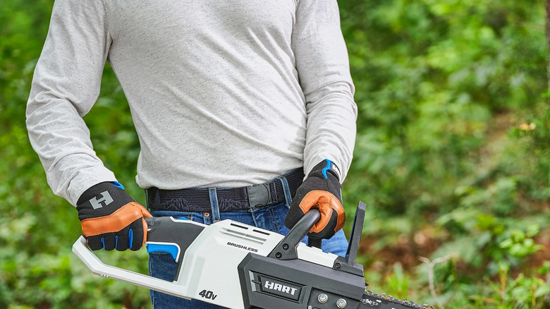 man holding chainsaw
