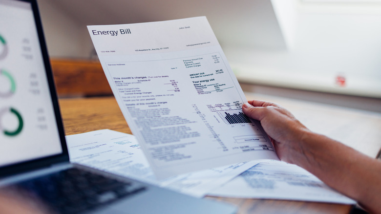 Person holding energy bill