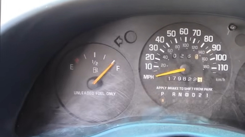 A vehicle's dashboard with gas gauge and speedometer featured