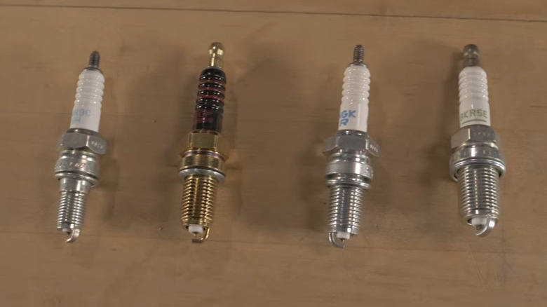 Four spark plugs on a table
