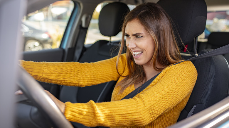 person looking angry in vehicle