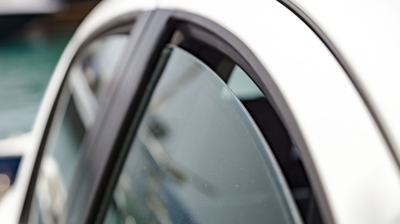 Partially cracked open car window during the day
