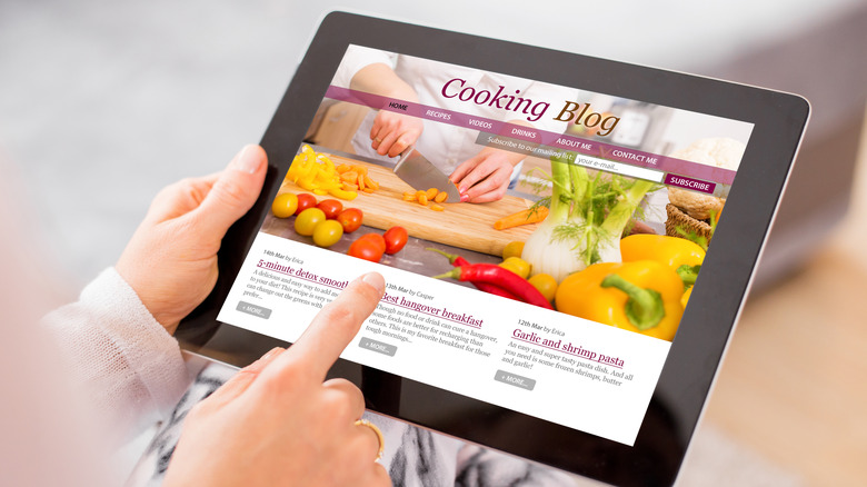 A person watching a cooking blog on an iPad