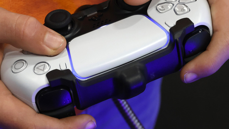 PlayStation 5 controller in hand