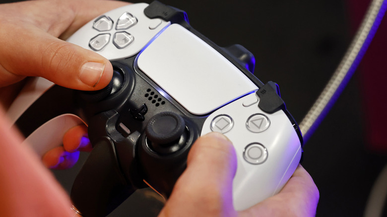 PlayStation 5 DualSense controller in hand