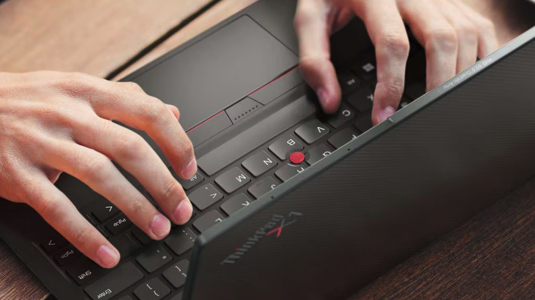 Man typing on a Lenovo ThinkPad