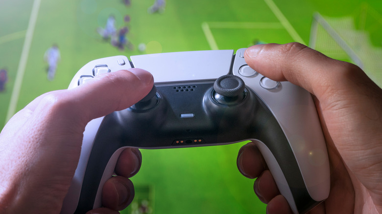 DualSense controller in hand