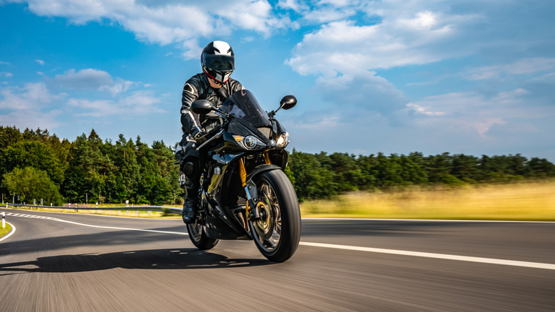 Person riding a motorcycle on road