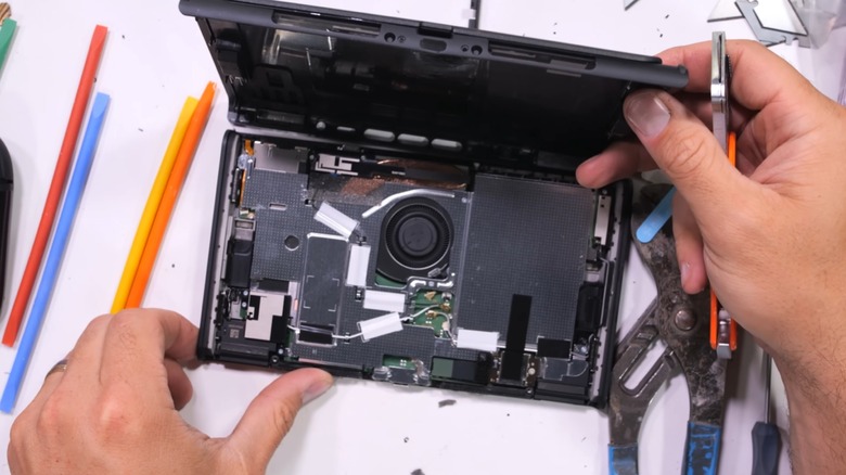 A Nintendo Switch 2 having its external shell opened, showing its internal components.
