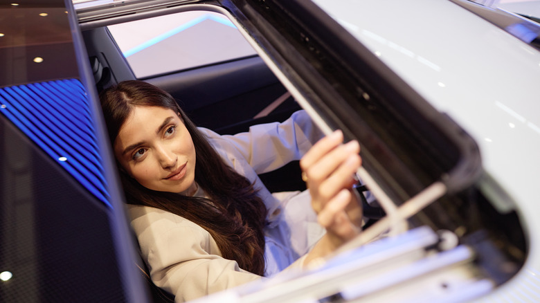 woman opening car sunroof