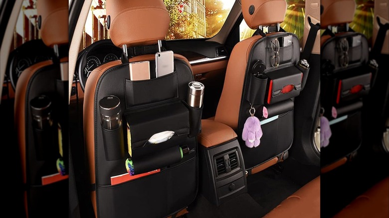 Two behind-the-seat storage units in a car with brown seats
