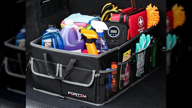 A box full of cleaning supplies and a first aid kit